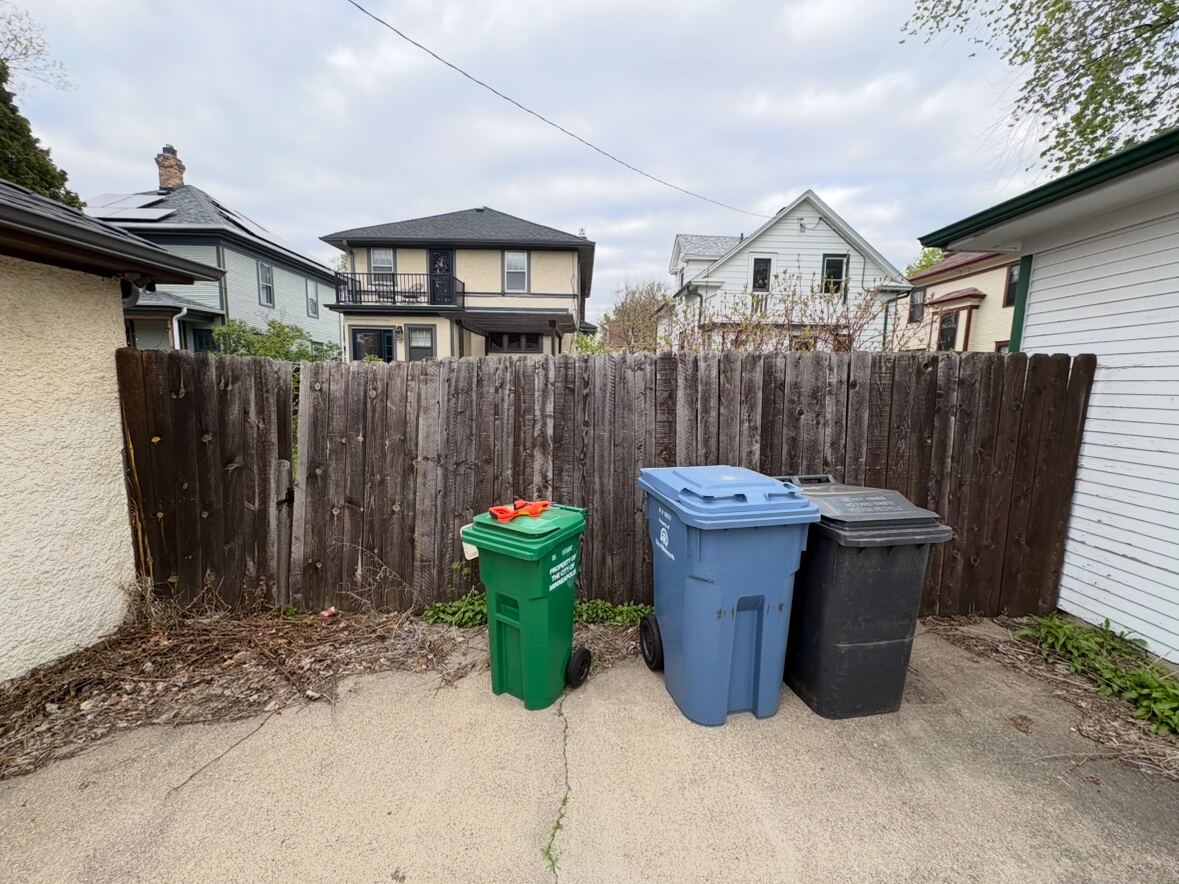 Before: weathered, aging privacy fence along an alley