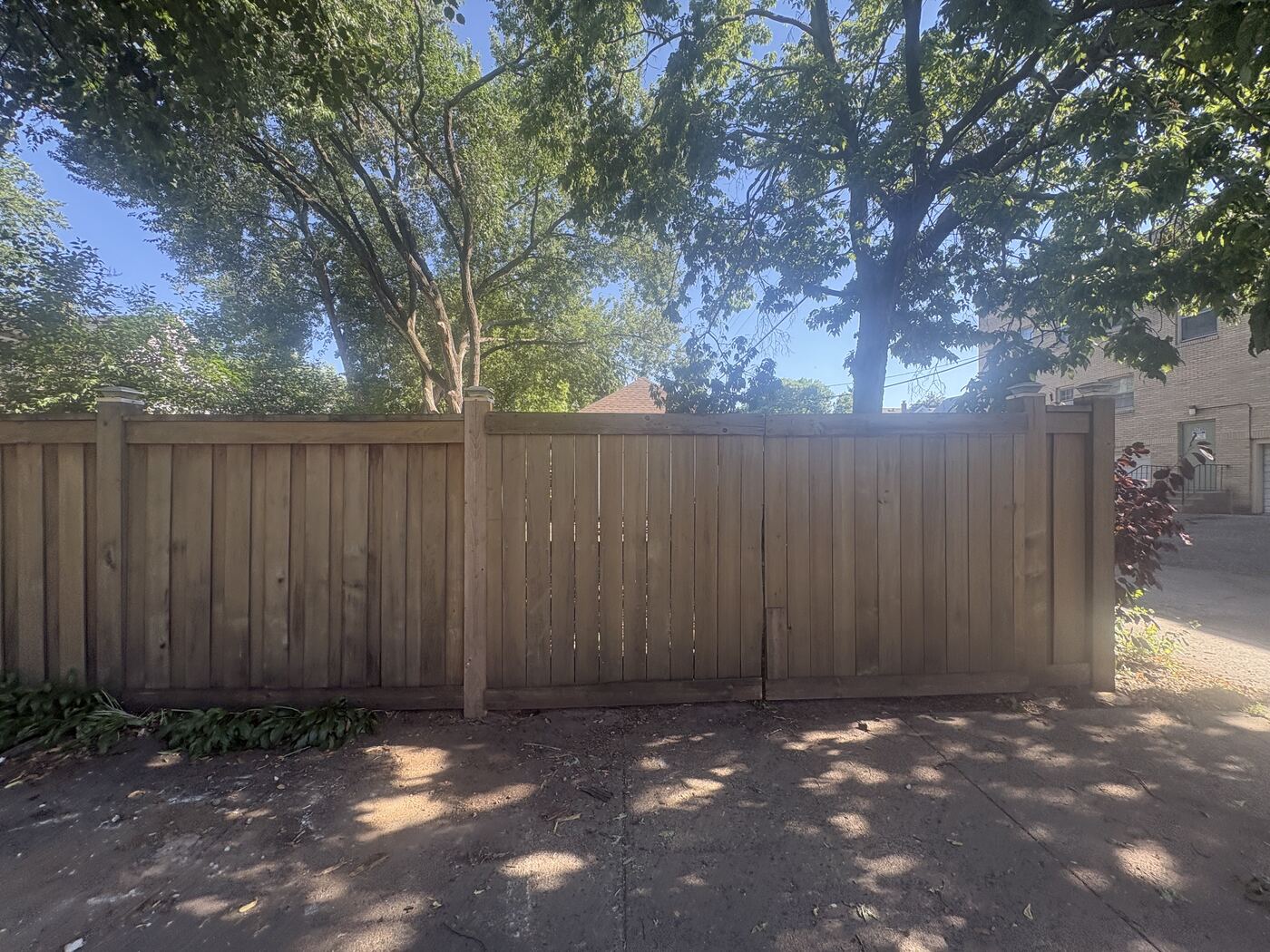 Cedar privacy fence with top cap along an alley