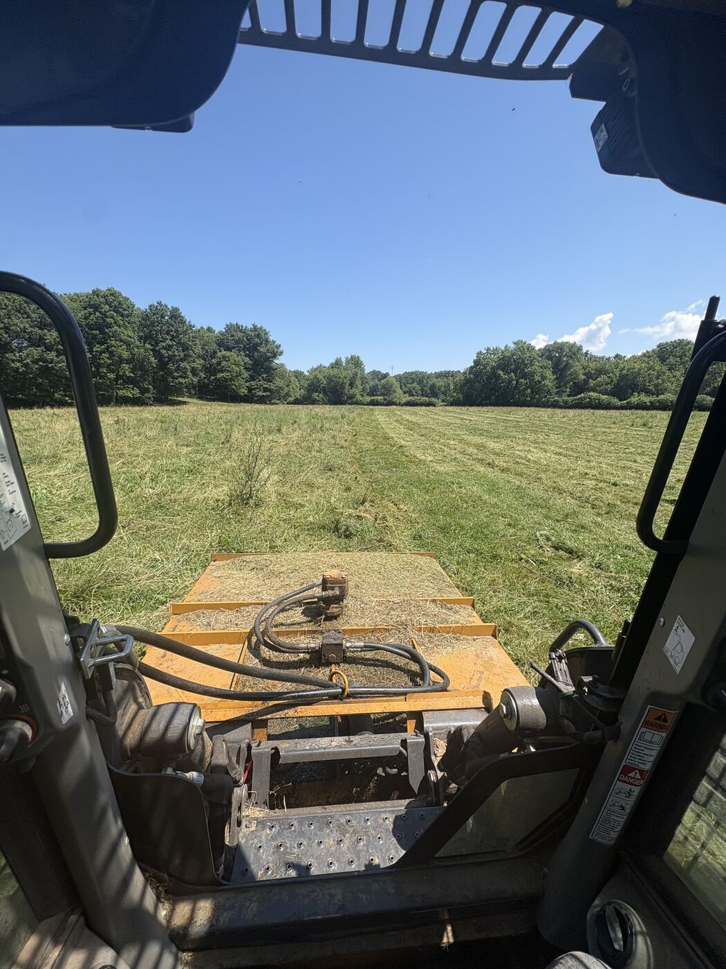Brush mowing a large field with a skid steer