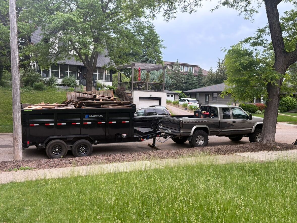 Dump trailer loaded with old fence debris for hauling